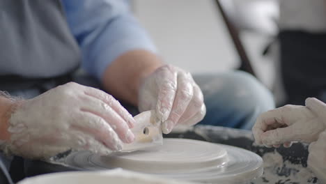 Close-up-of-a-male-master-working-on-a-potter's-wheel-close-up-in-slow-motion